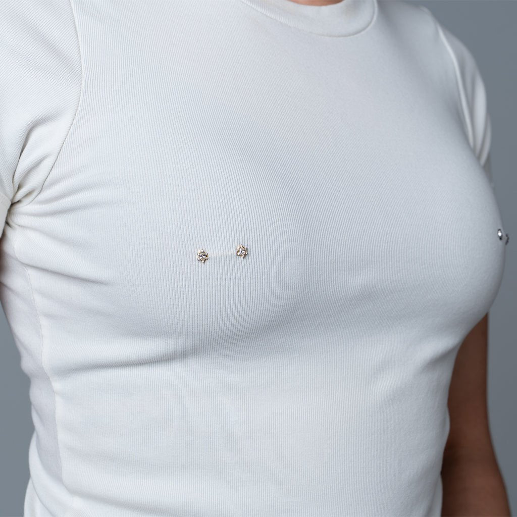 Gold-tone nipple bar with oval clear cubic zirconia halo ends