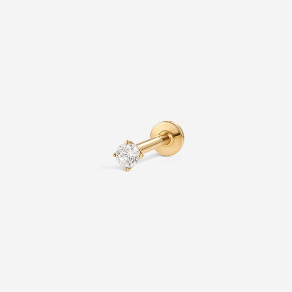 Gold flatback piercing with a clear prong-set cubic zirconia and straight post, angled view