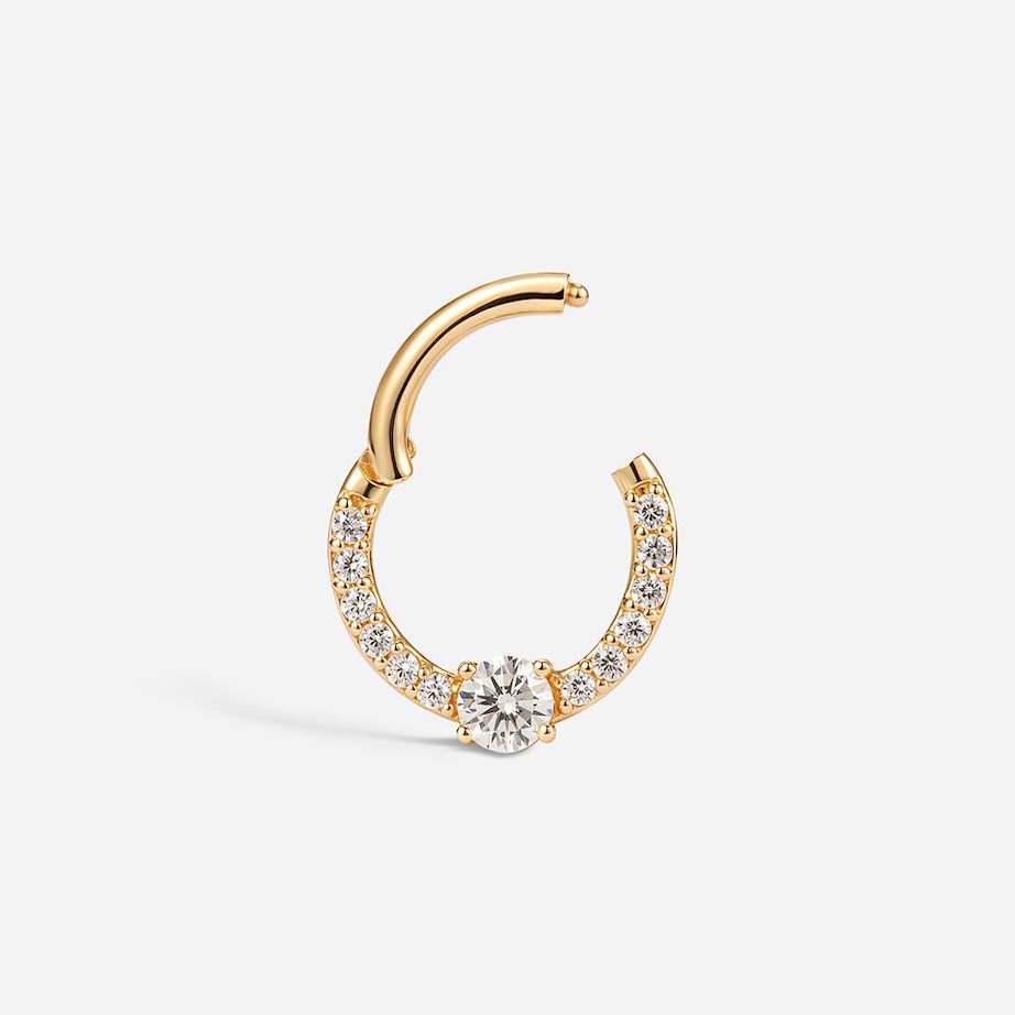 14K solid gold segment ring with a large round clear CZ and smaller stones along the band