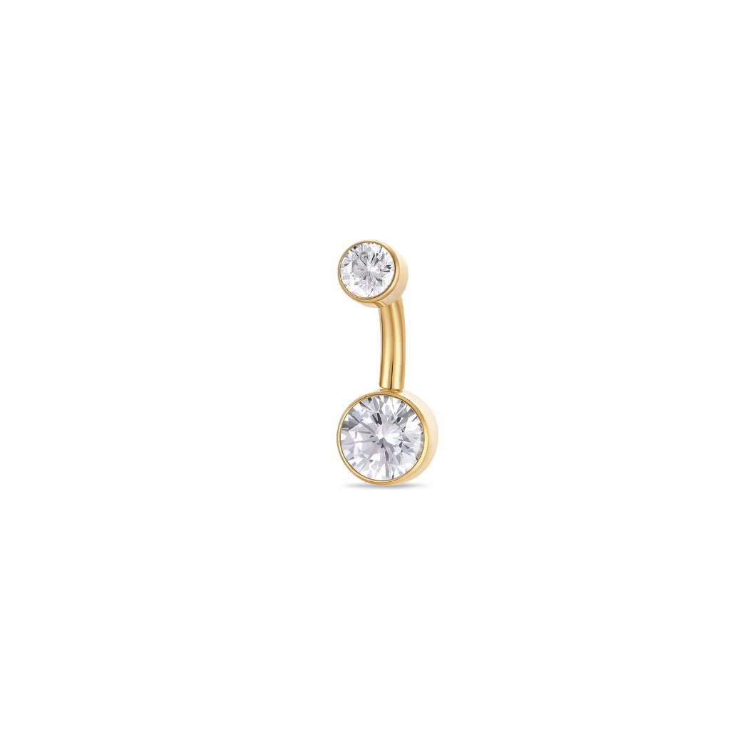 Titanium navel bar with round bezel-set clear cubic zirconia in gold tone, implant grade titanium body, studio product image.