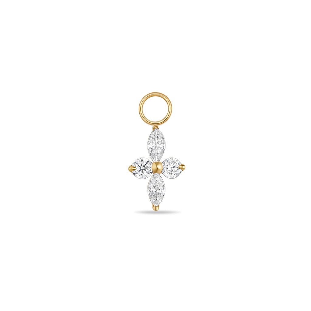 Gold-tone titanium four-point star charm with marquise and round cubic zirconia stones and jump ring.