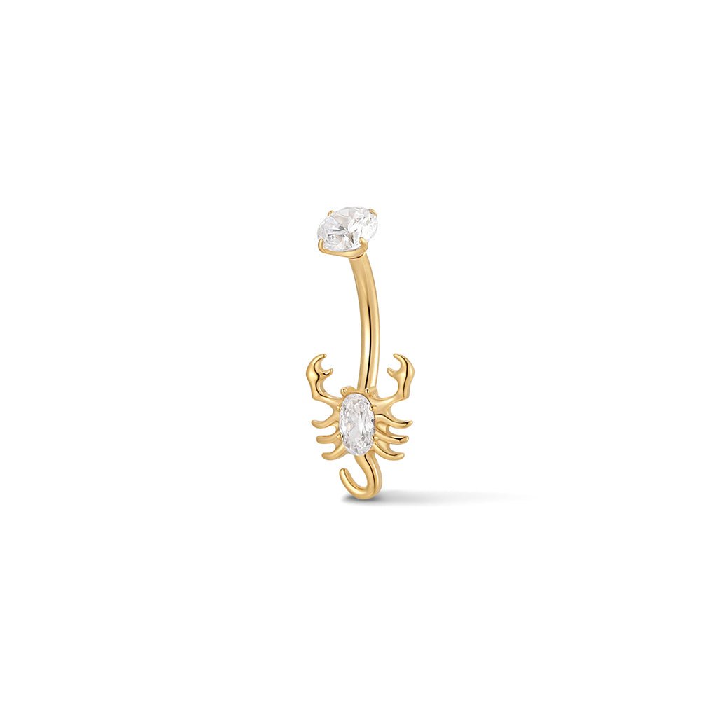 Gold-tone navel bar with scorpion design, featuring clear and red cubic zirconia stones
