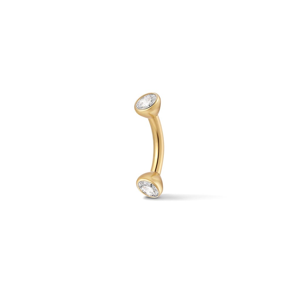 Gold-tone bezel-set cubic zirconia curved barbell piercing
