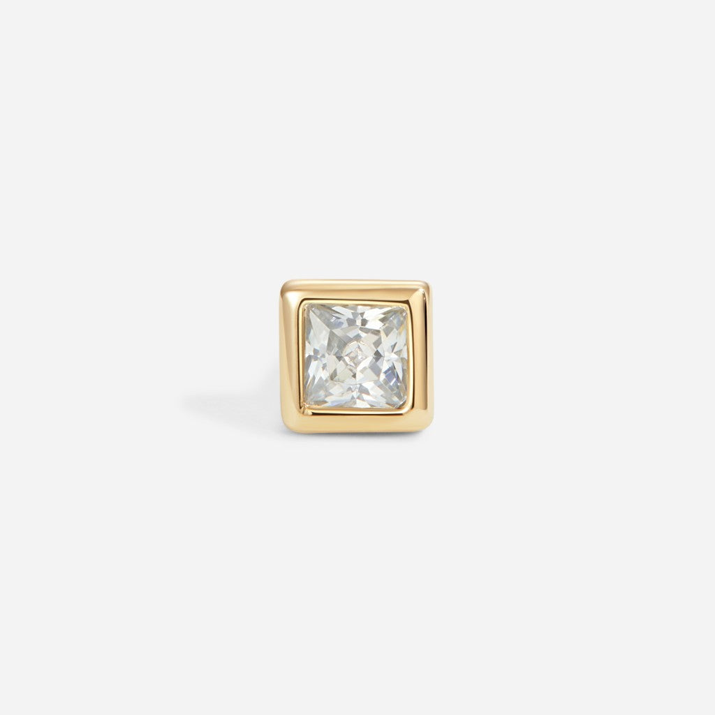 Gold square bezel-set flatback stud featuring a clear princess-cut cubic zirconia stone in a minimalist geometric design.