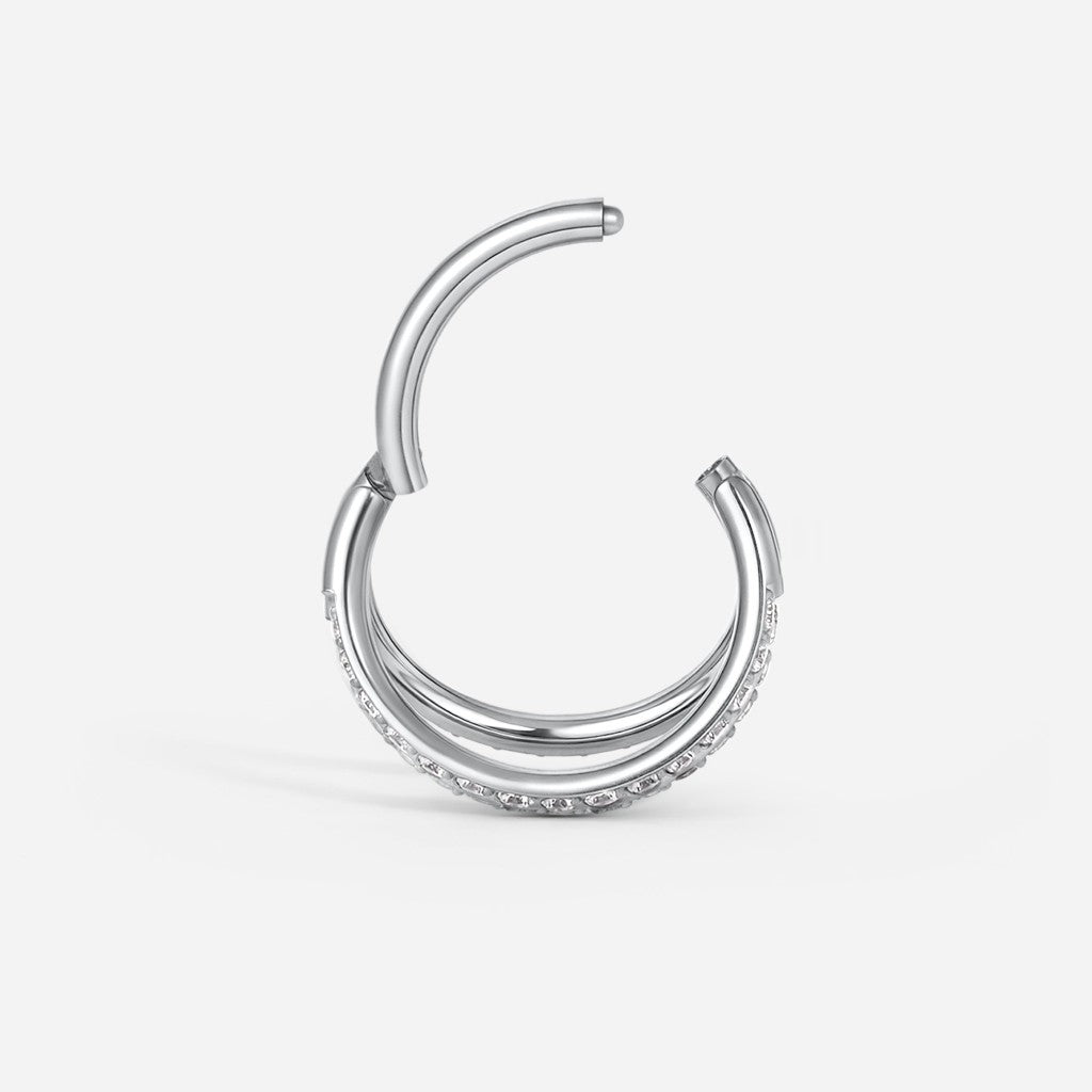 Silver titanium cubic zirconia triple hoop segment ring.
