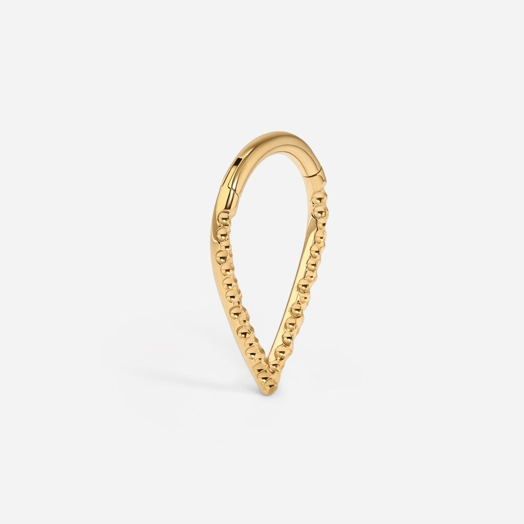 Gold titanium hammered v-shape segment ring.
