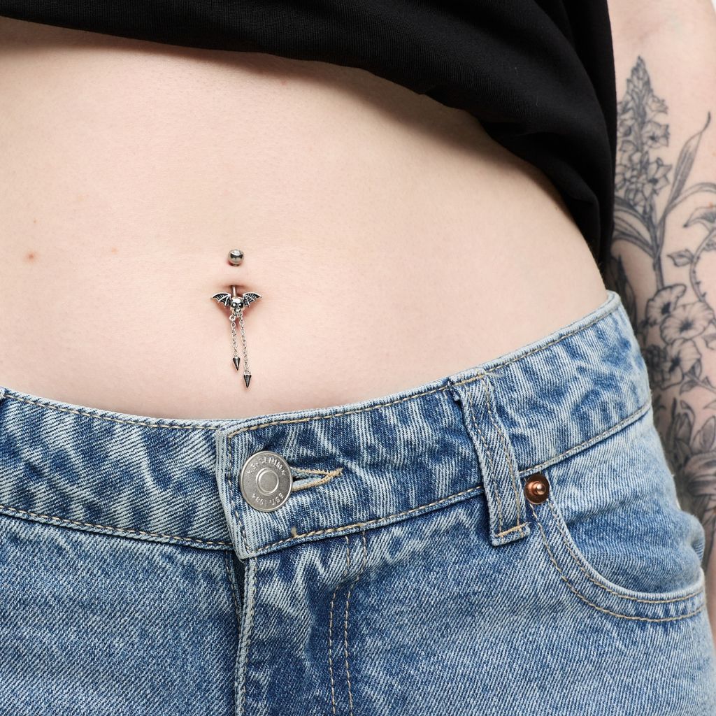 Navel belly button piercing with skull wing spike dangle, clear stones and black accents