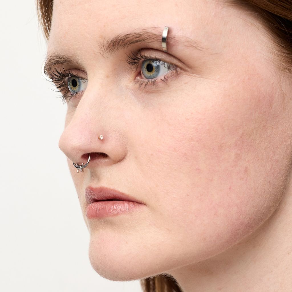 Small titanium nose ring with hinged circular design