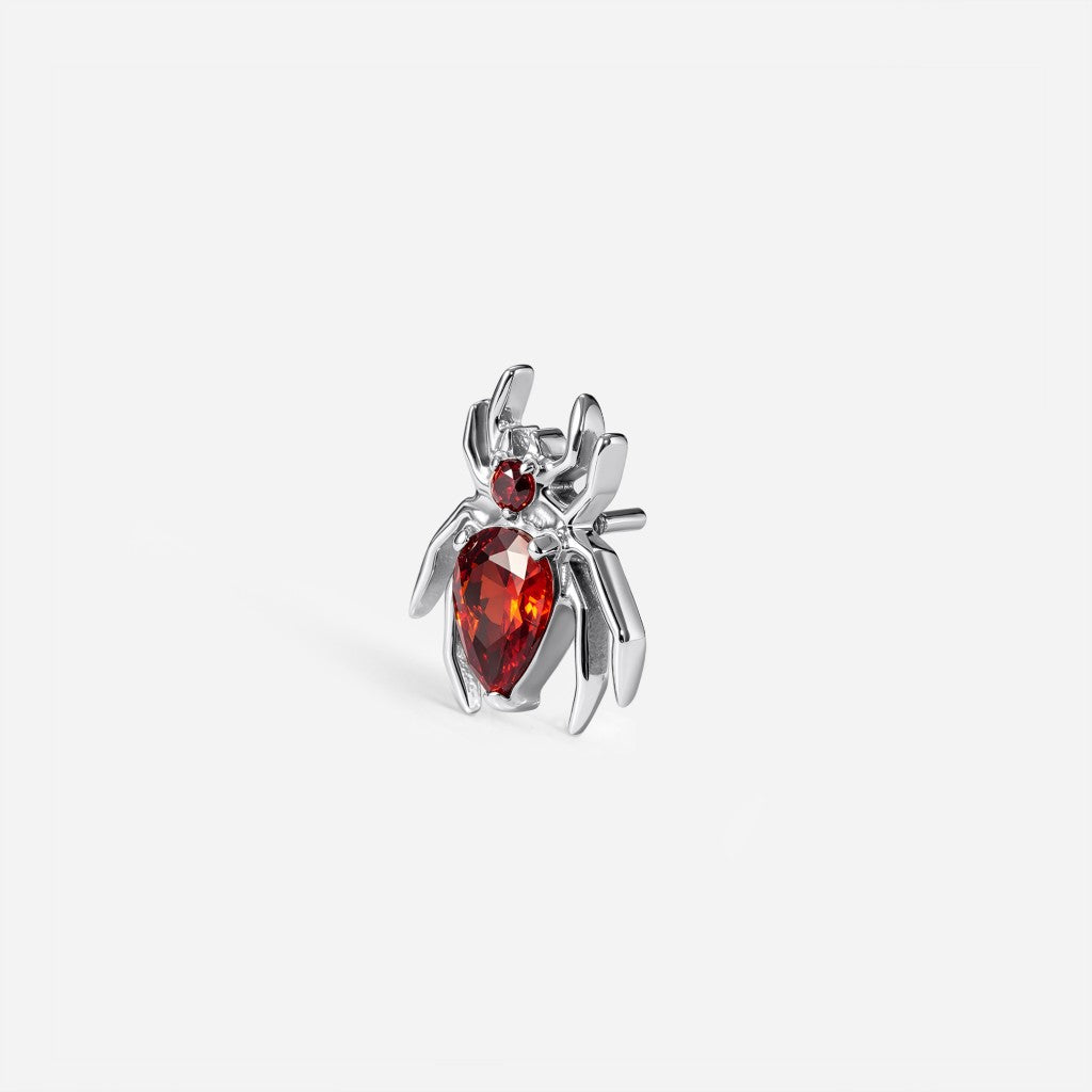 Titanium guided internally threaded spider top with a red cubic zirconia accent.
