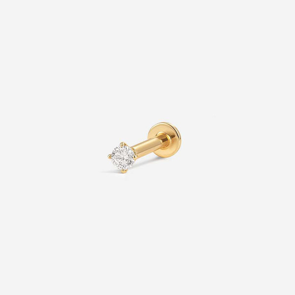 Gold labret piercing with a round clear stone in a prong setting, shown with post and flat back